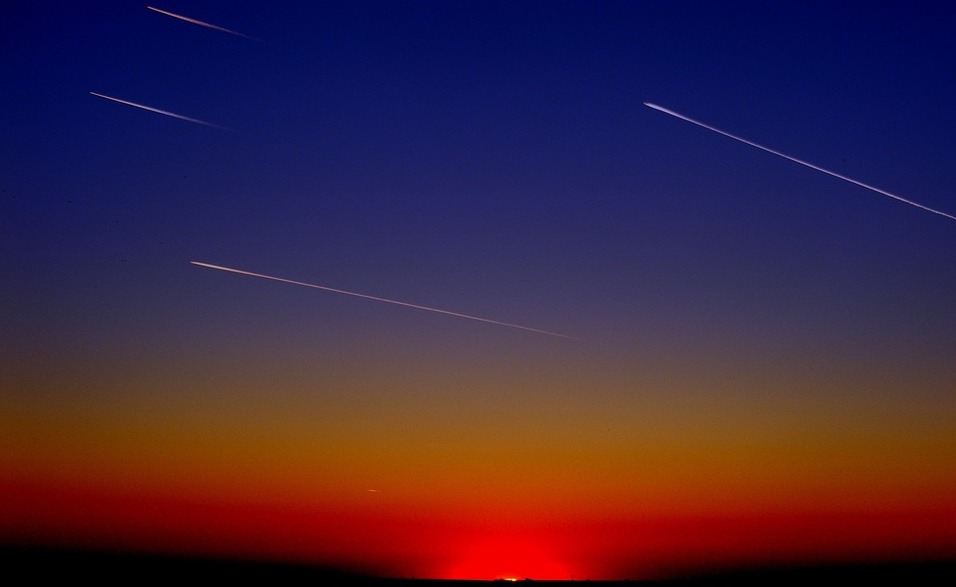 Multiple comets shooting through the sky.